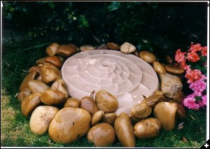 [An Amonite water feature which the frogs love, is in our garden in Remembrance of Angela]