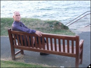 [Mike, sitting on Angela's & David's  Memorial Bench in Brixham]